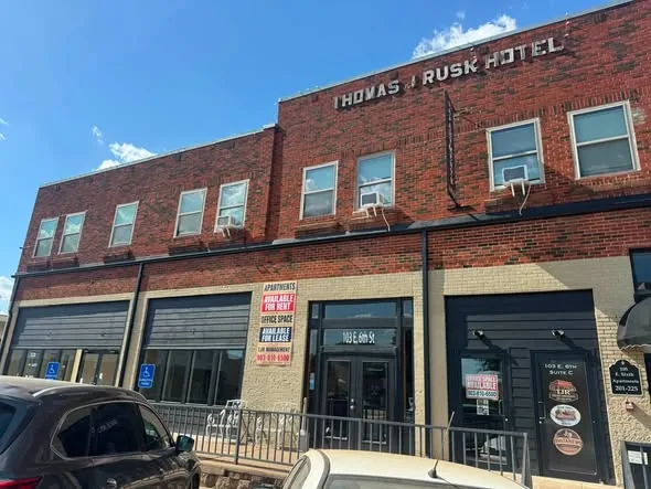 Dark downspouts on the red brick facade of the Thomas J Rusk Hotel