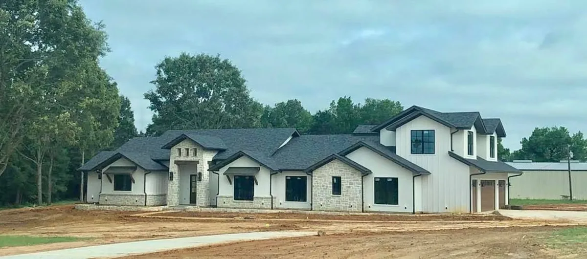 Dark gutters tracing the roofline of a white two-story home